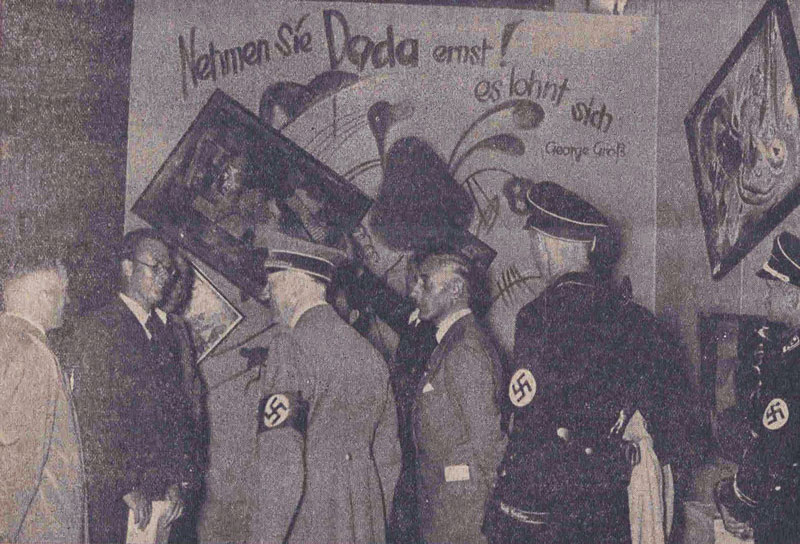 Adolf Hitler and other Nazi officials take in the Dada wall at the “Entartete Kunst” (“Degenerate Art”) exhibition in Munich on July 16, 1937. Originally published in the Nationalist Observer, South German issue, No. 199, July 18, 1937.